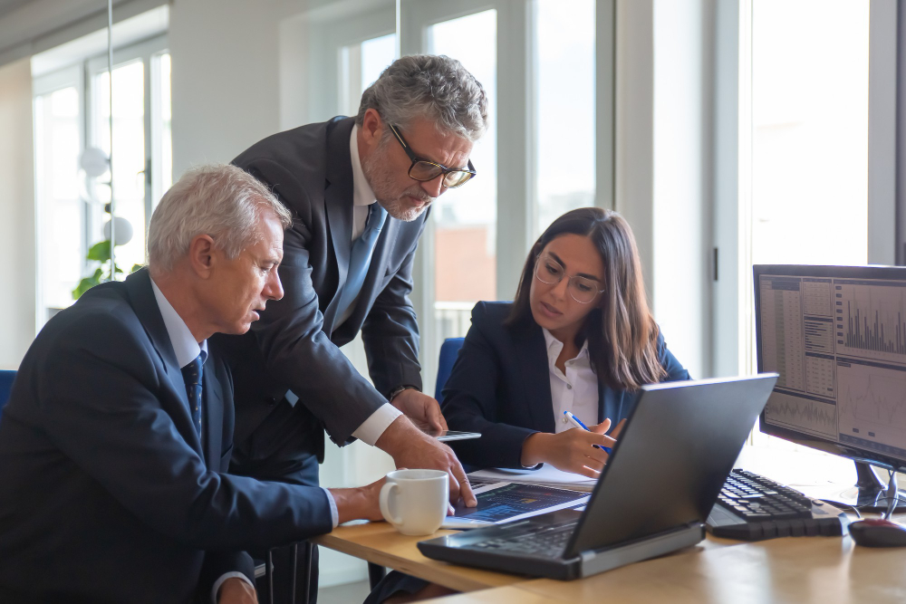 concentrated colleagues watching statistic charts talking about work professional senior managers young assistant preparing business plan teamwork management partnership concept 1