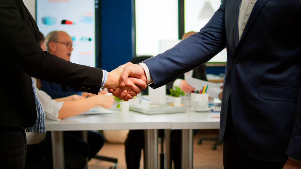 satisfied businessman company employer wearing suit handshake new employee get hired job interview male hr manager employ successful candidate shake hand business meeting placement concept