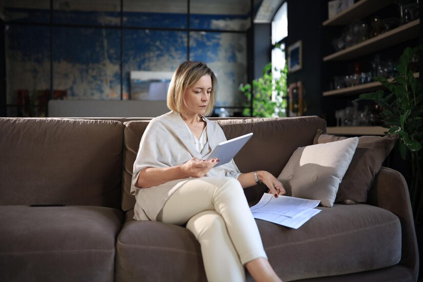 cheerful middle aged woman sitting sofa using computer tablet apps looking screenreading good news social network shopping chatting online 484651 17482