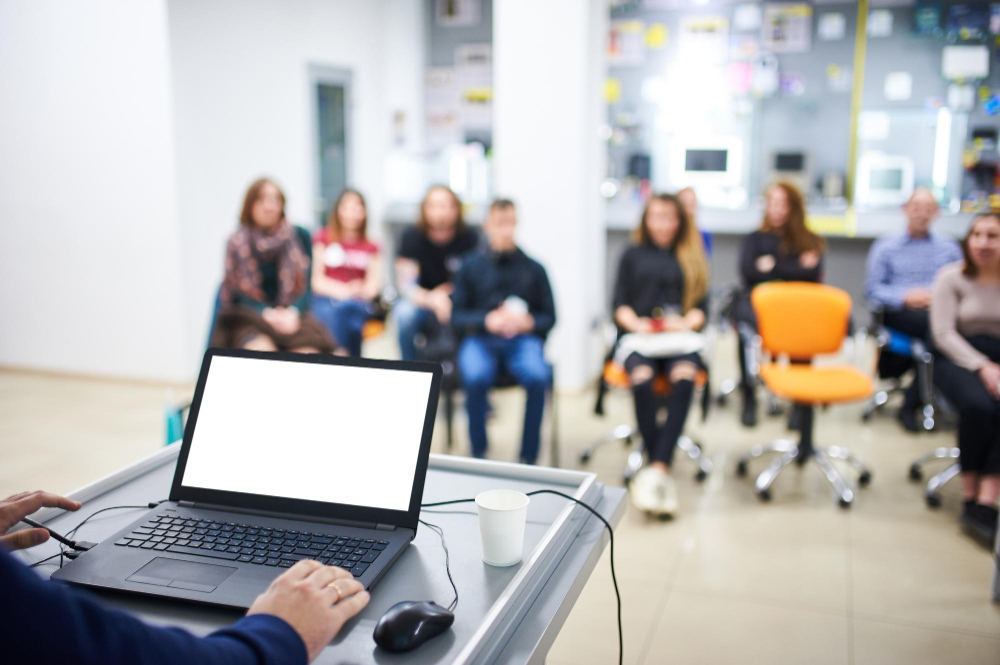 blank screen laptop computer with blurred people background