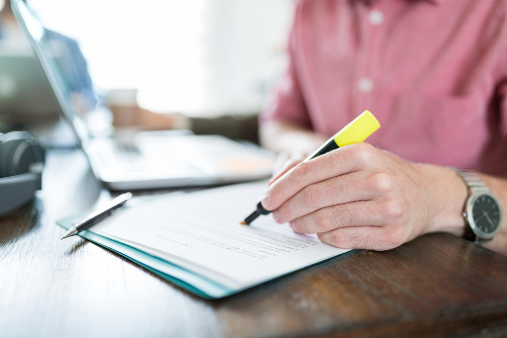 businessman writing document with felt tip pen desk workplace