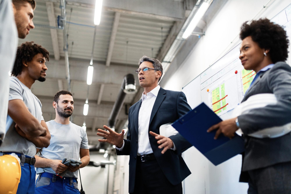 factory manager holding meeting talking his employees about project plans