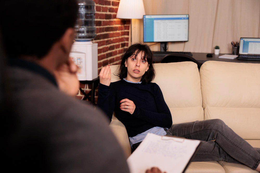 unhappy woman laying sofa psychotherapy session with therapist talking about stress problems receiving support help from professional counselor behavior guidance