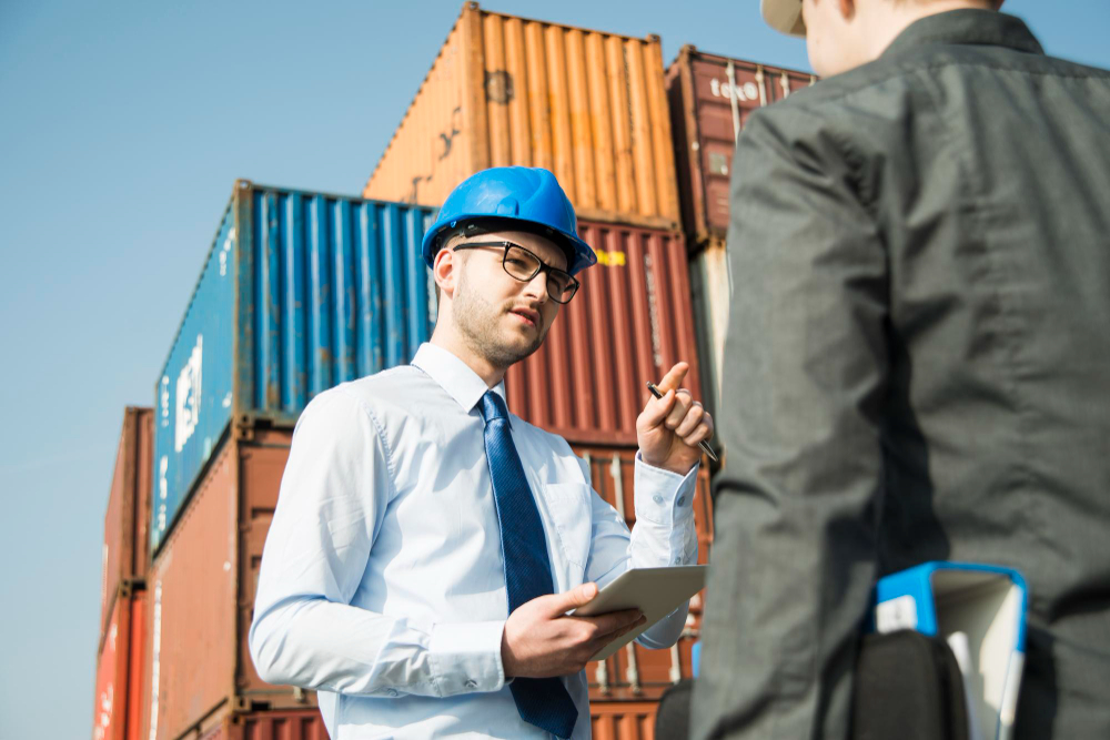 businessman talking teenager container terminal