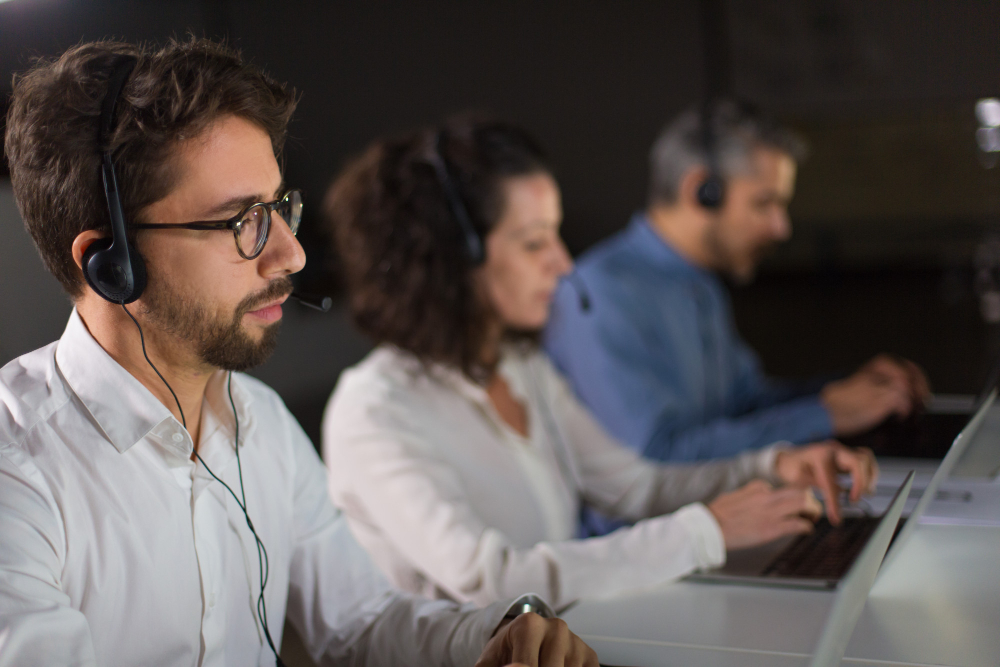 concentrated bearded call center operator working